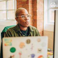 Black woman concentrating on her computer screen.