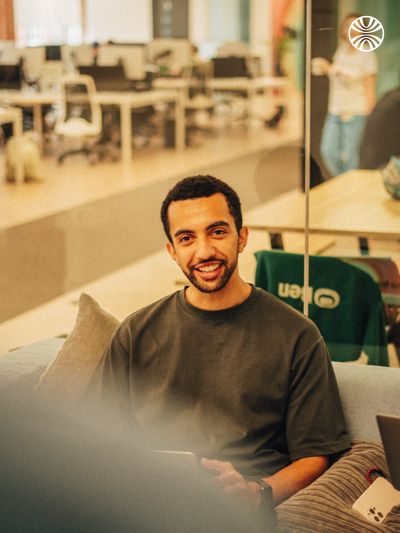 Man smiling while working in an office.