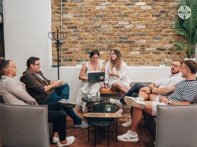 Group having a casual meeting in a cozy office lounge area.