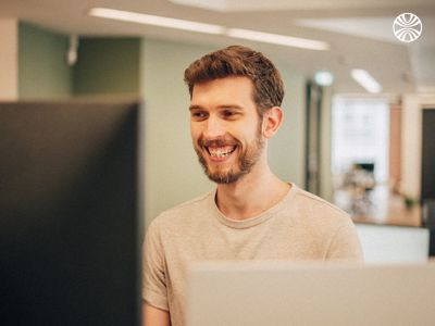 Man smiling while working at his desk.