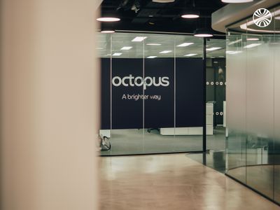 Modern office entrance with glass doors displaying "Octopus - A brighter way" text on a purple wall.