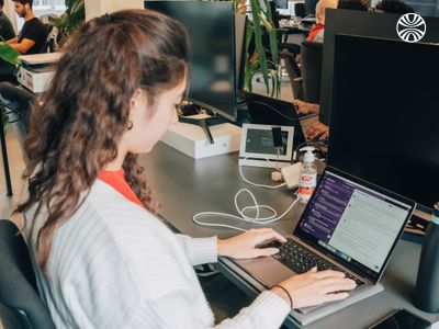 White woman focused on her laptop.