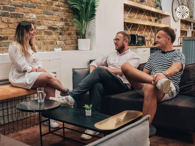 Small group meeting in a comfortable office setting with a wooden coffee table.